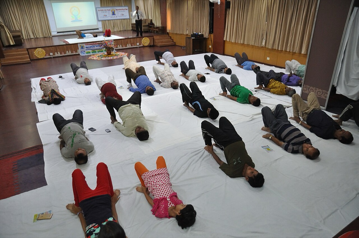 Group yoga class in Kolkata on International Day of Yoga, participants in Setu Bandhasana, Bridge Pose